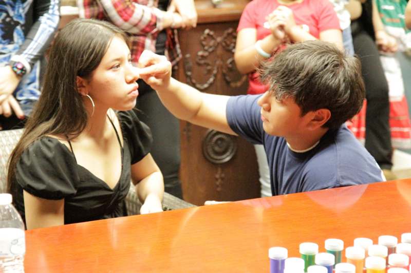 a man putting a finger on a woman's nose