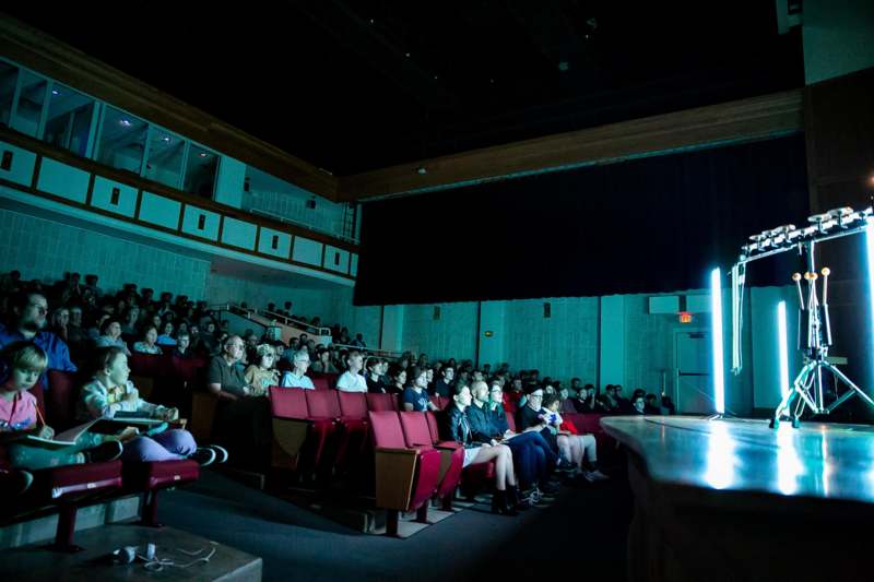 a group of people sitting in a theater