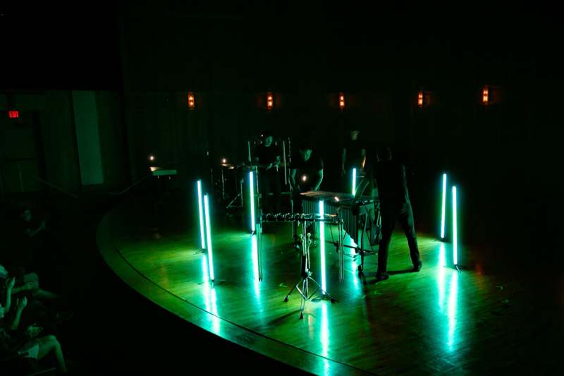 a group of people on a stage with lights