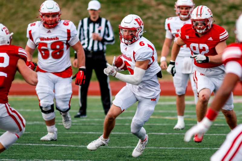 a football player running with a football in his hand