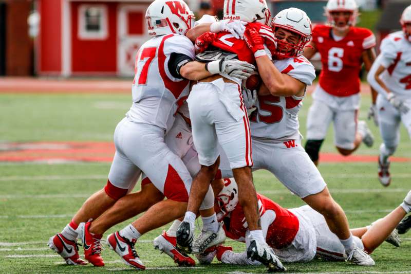 a group of football players hugging