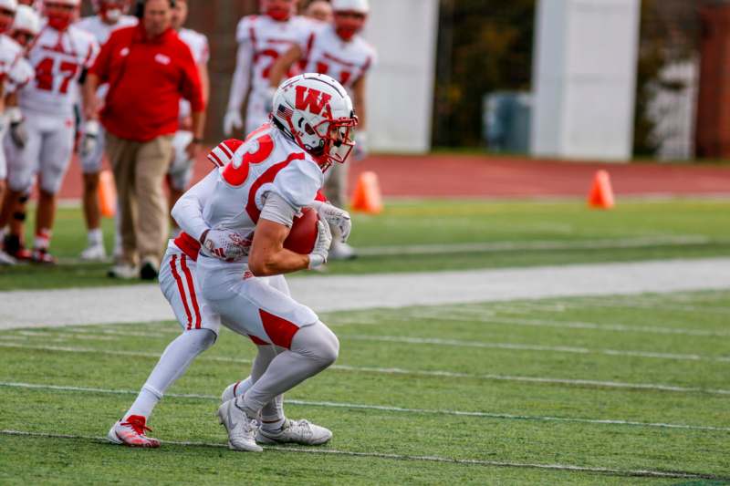 a football player holding a football