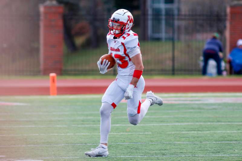 a football player running with a football