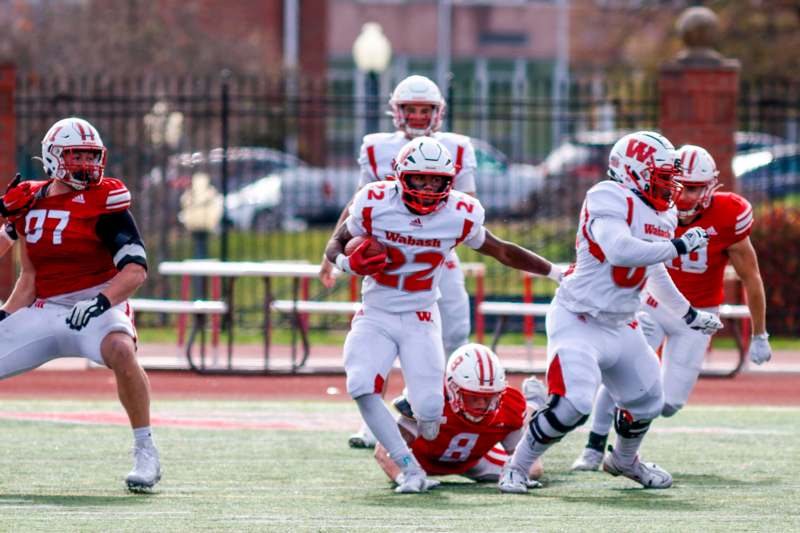 a group of football players running on a field