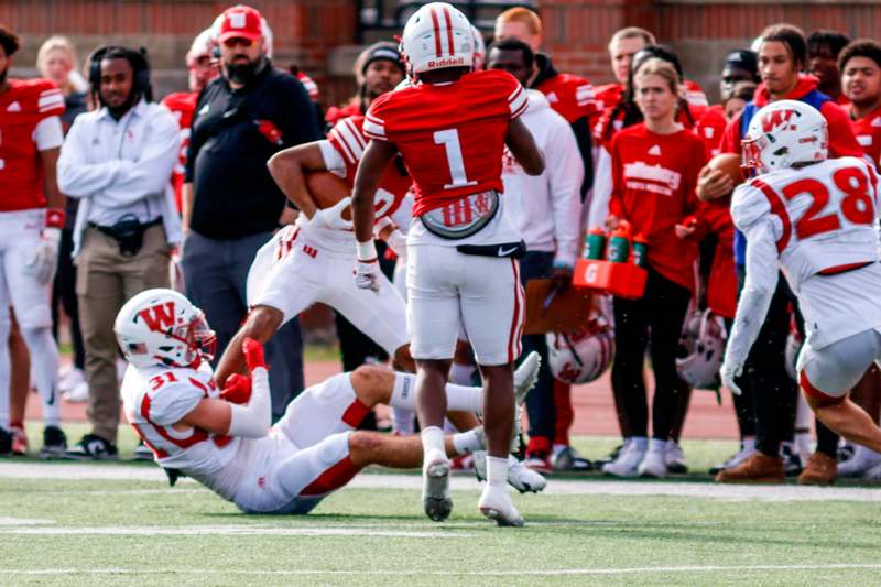 a football player falling off the ground