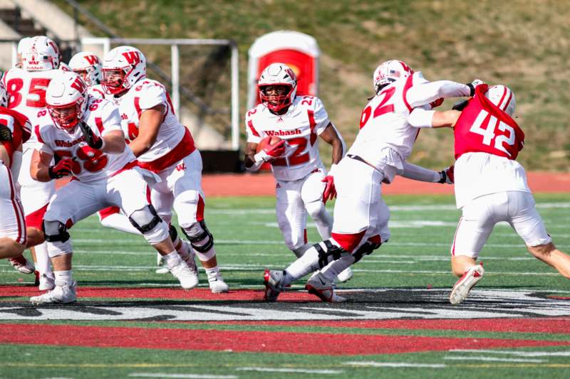 a group of football players running on a field