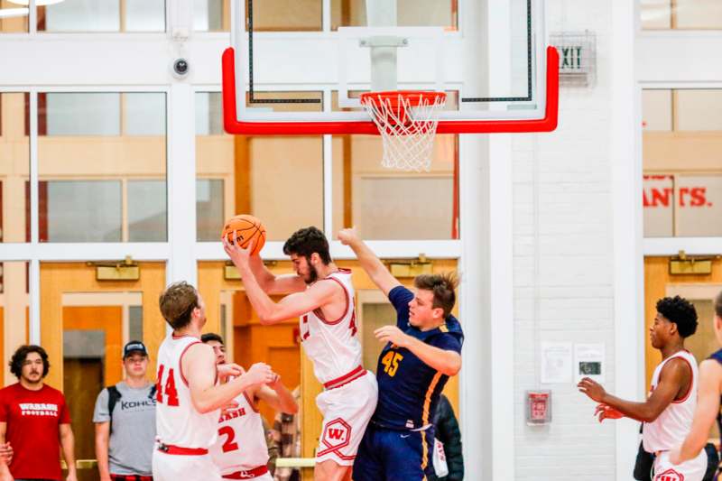 a group of men playing basketball