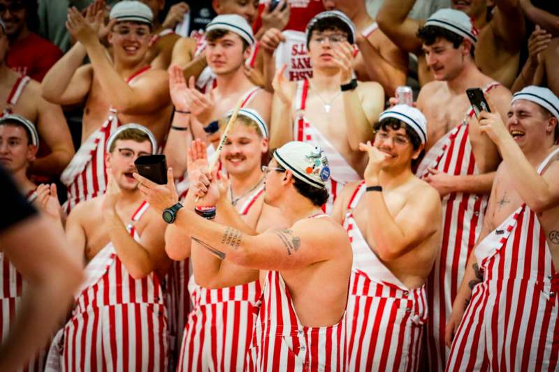 a group of men wearing striped overalls