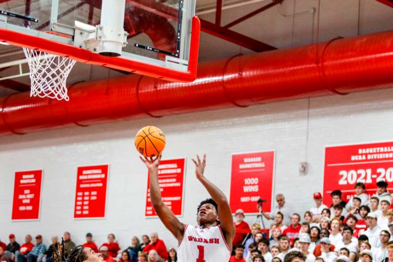 a man playing basketball in a gym