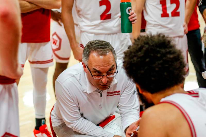 a basketball coach talking to a group of men