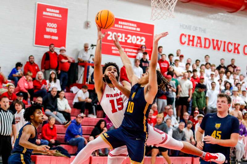 a basketball player in action with a basketball in the air