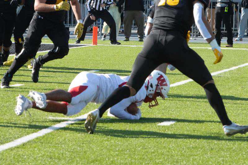 a football player diving for a ball