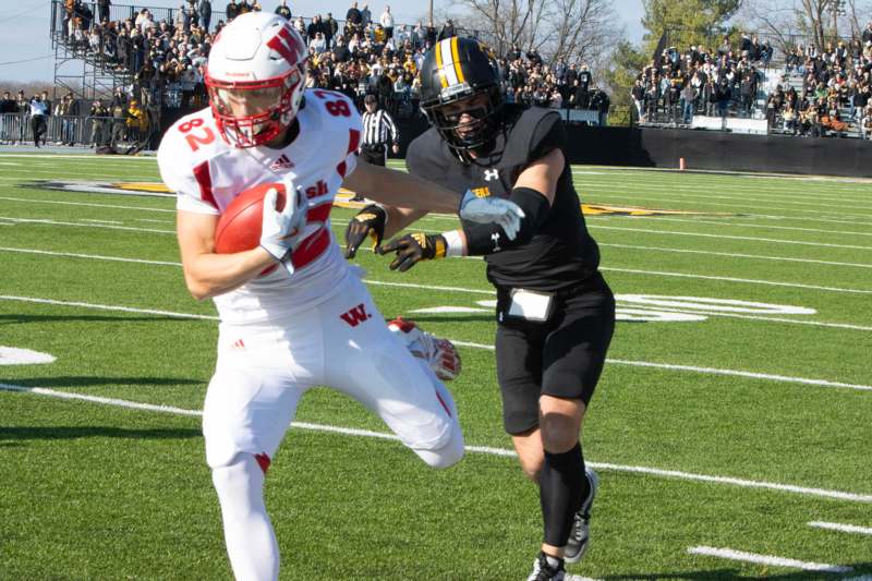 a football player running with a football in his hand