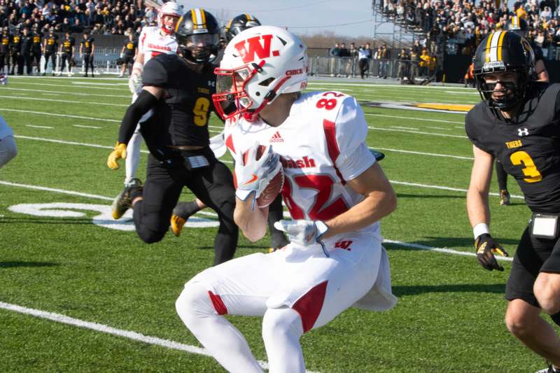 a football player running with a football in his hand