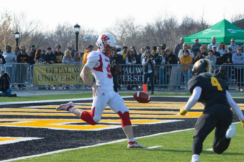 a football player running with a football in the air