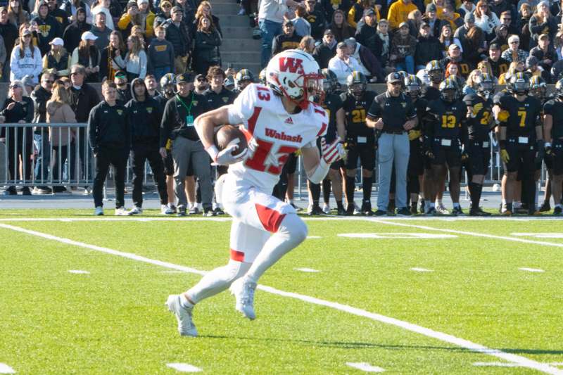 a football player running with a football in his hand