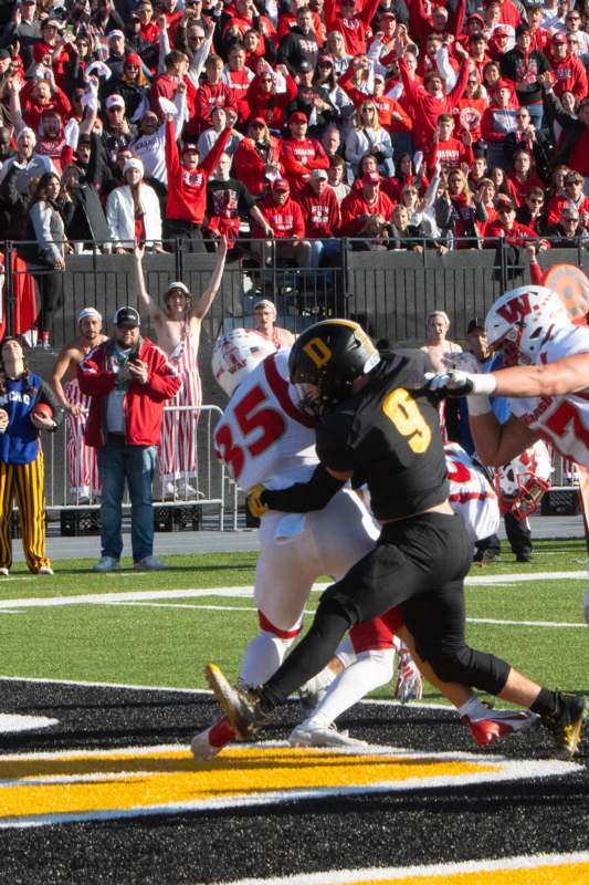 a football player in a black uniform playing a game