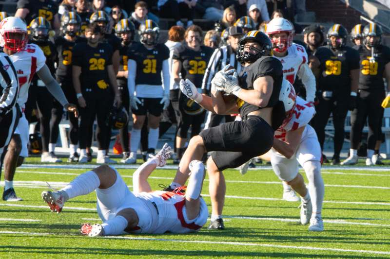 a football player falling down while another player is falling