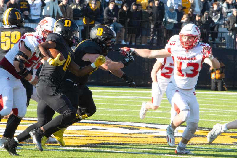 a group of football players running on a field