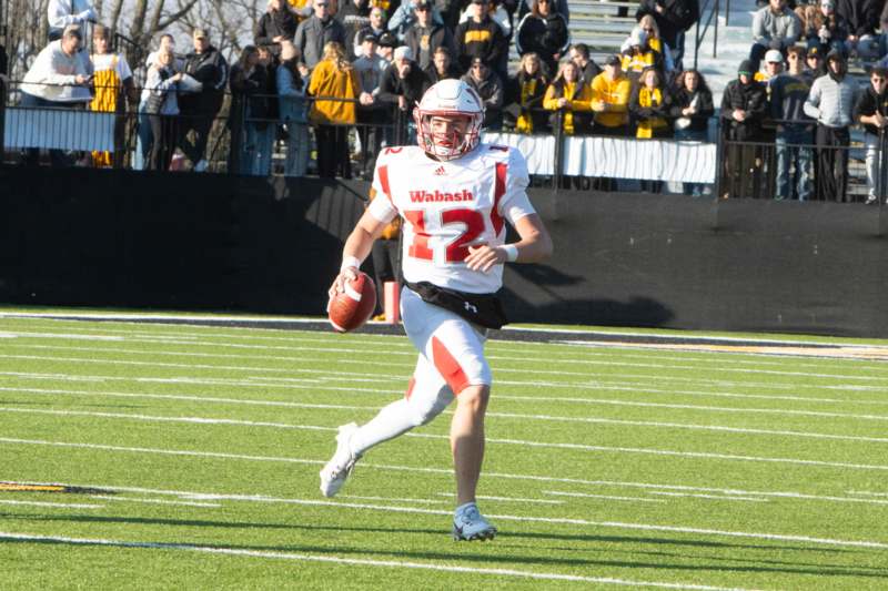 a football player running with a ball on a field