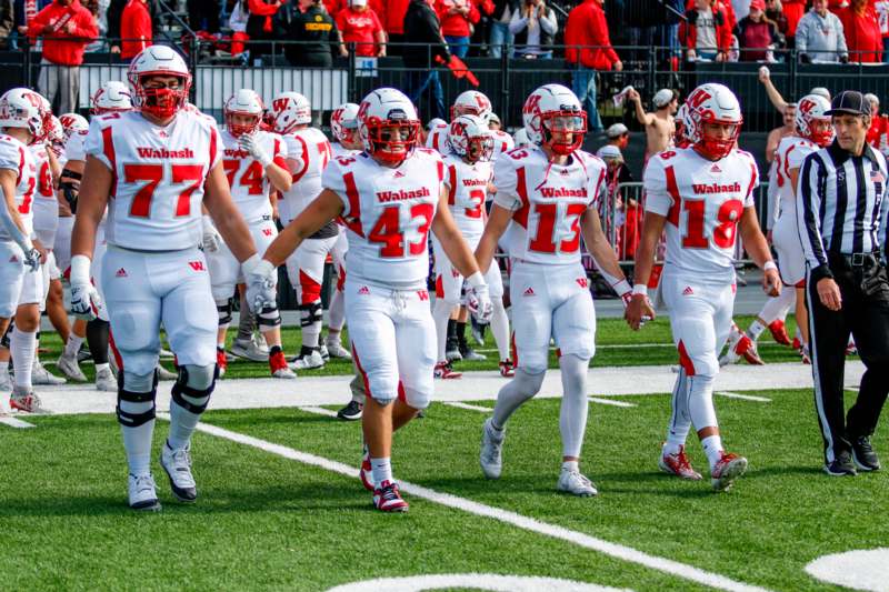 a group of football players walking on a field