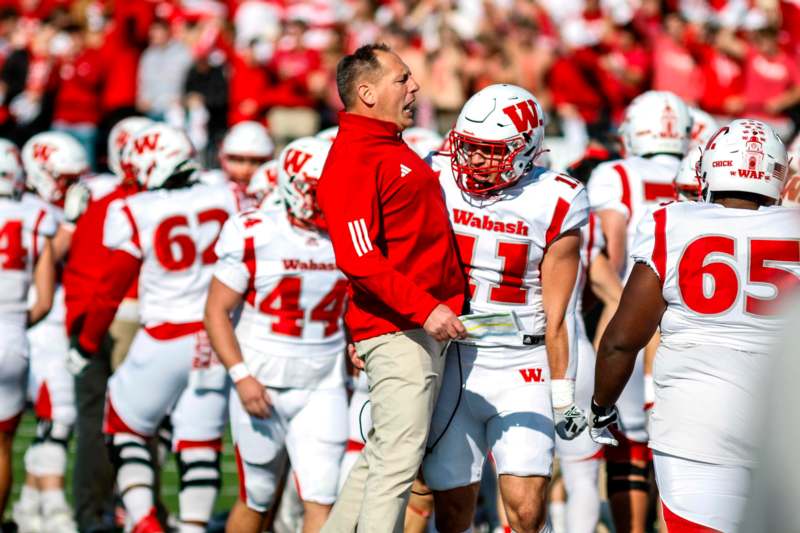 a football coach talking to a football player