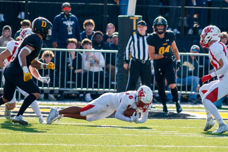 a football player diving for a ball