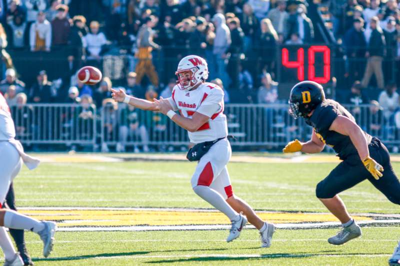 a football player running with a football in the air