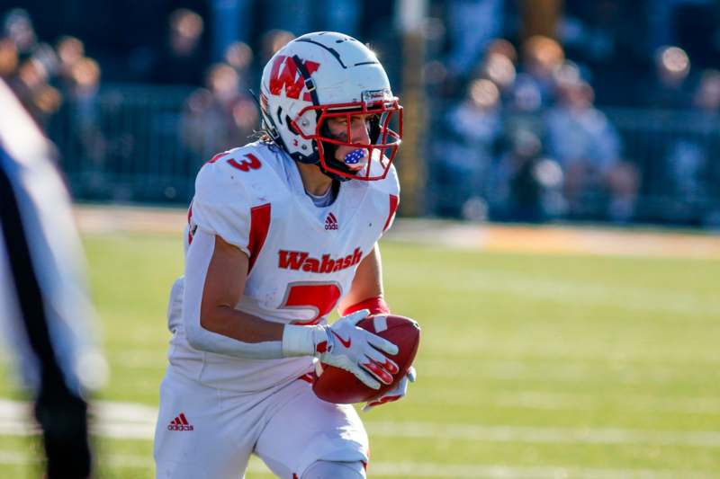 a football player holding a football