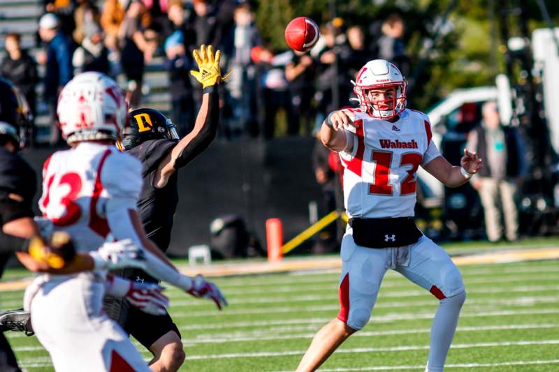 a football player throwing a football