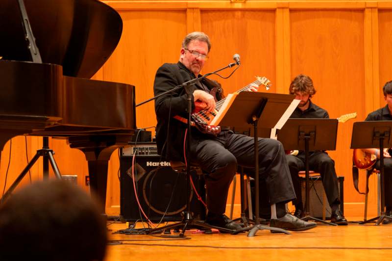 a man playing a guitar and a piano