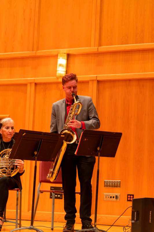 a man playing a trumpet and a woman playing instruments