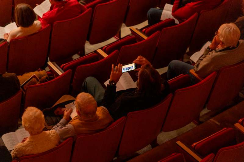 a group of people sitting in a theater