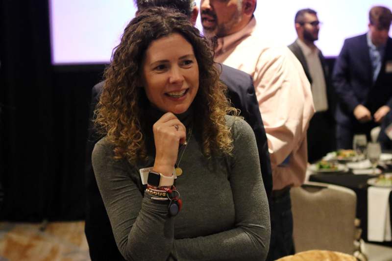 a woman with curly hair and a smart watch