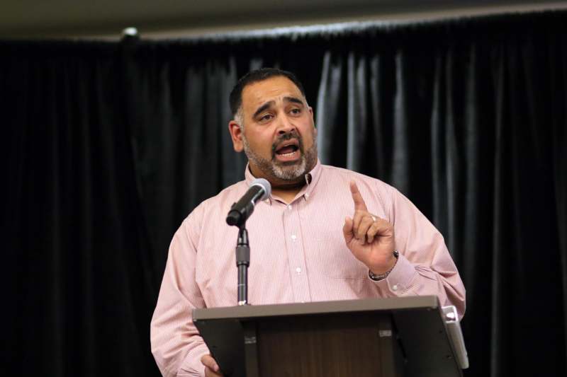 a man standing at a podium with a microphone