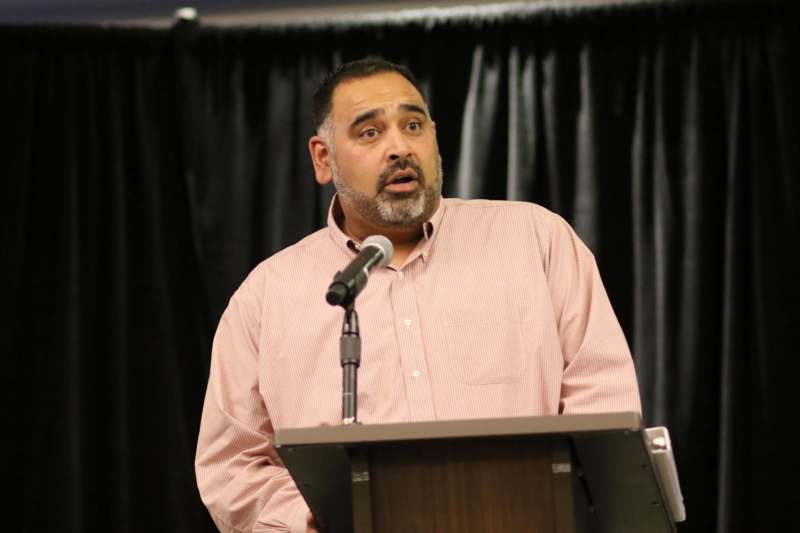 a man standing at a podium with a microphone