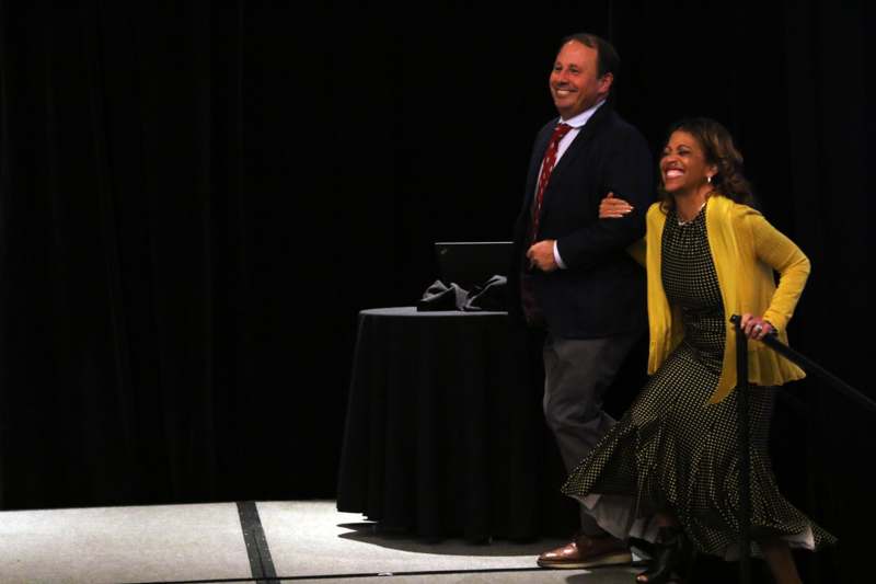 a man and woman standing on a stage