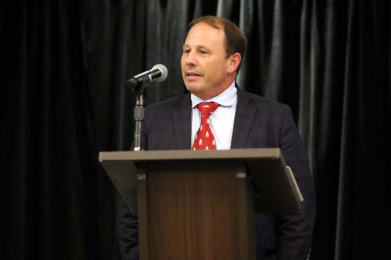 a man standing at a podium with a microphone