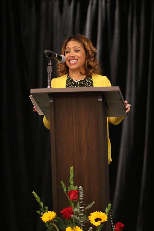 a woman standing at a podium with a microphone