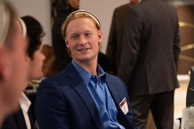 a man in a blue shirt and suit