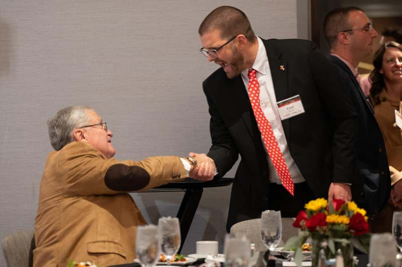 a man shaking hands with another man