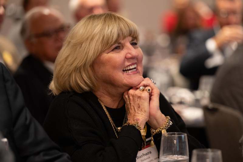 a woman smiling at a table