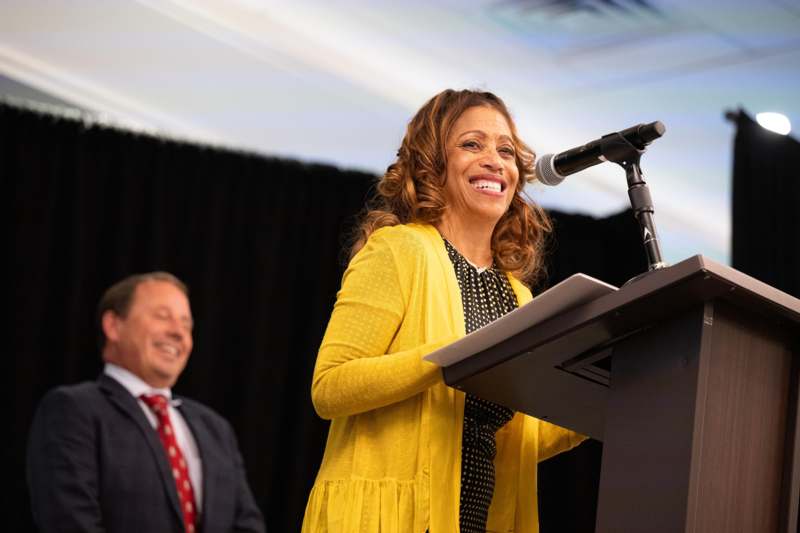 a woman standing at a podium with a microphone