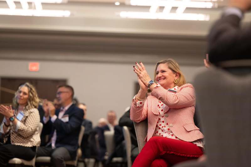 a woman sitting in a chair clapping