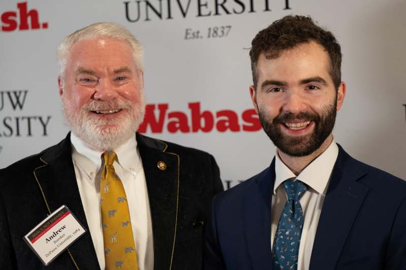 two men standing together smiling