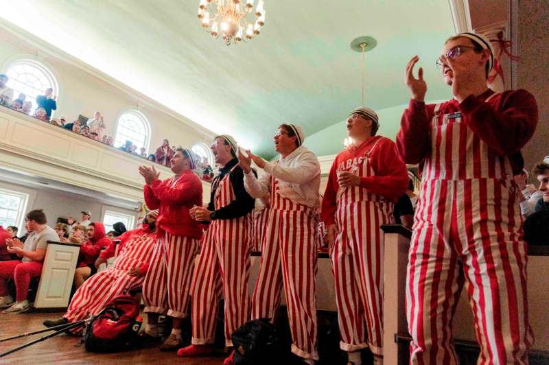 a group of people wearing striped overalls