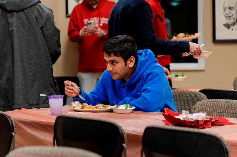 a man sitting at a table with food on it