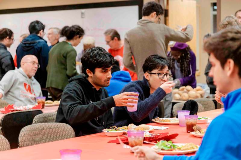 a group of people sitting at a table eating food