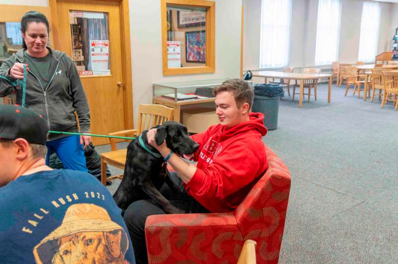 a man sitting in a chair with a dog