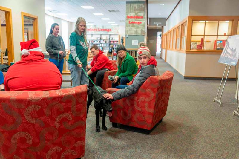 a group of people sitting in chairs with a dog